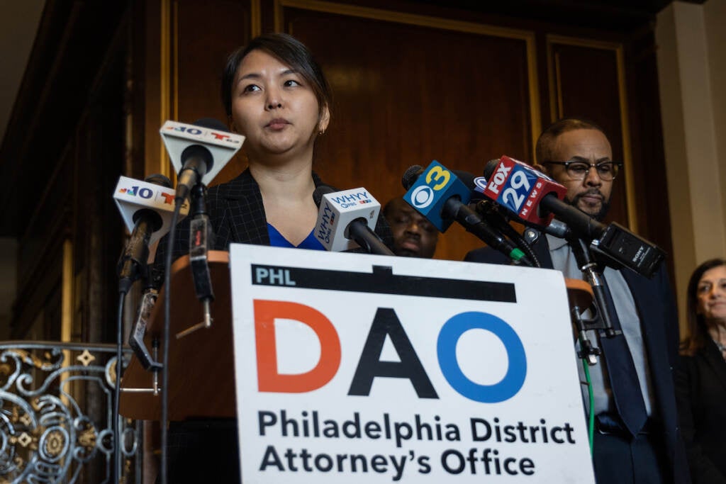 A woman stands at a podium.