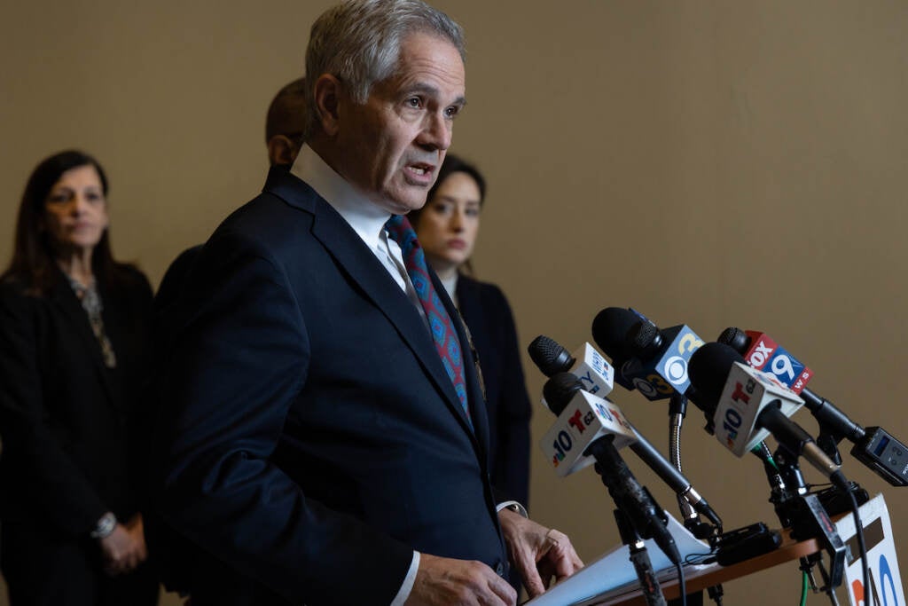 Philadelphia DA Krasner speaks at a podium.