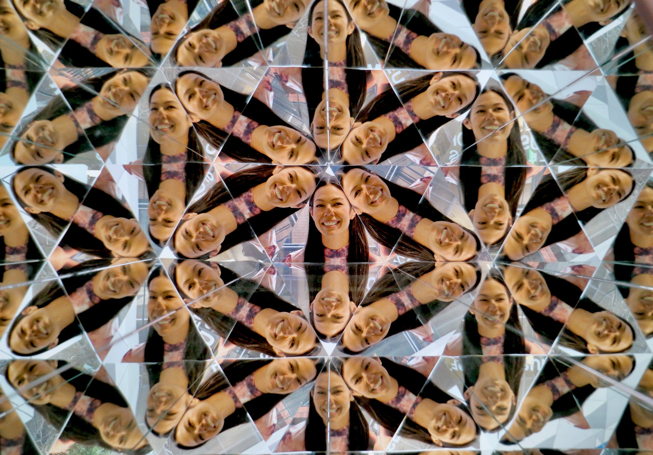 Stacy Rangel Stec is multiplied by a large kaleidoscope at the Museum of Illusions