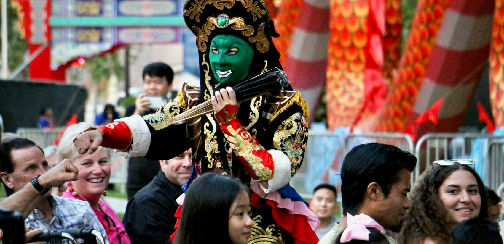 A face-changing performer mingles with the crowd during a performance at the Chinese Lantern Festival