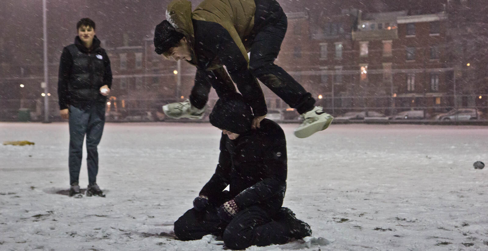 Teenagers play in the snow at Frank Palumbo Recreation Center
