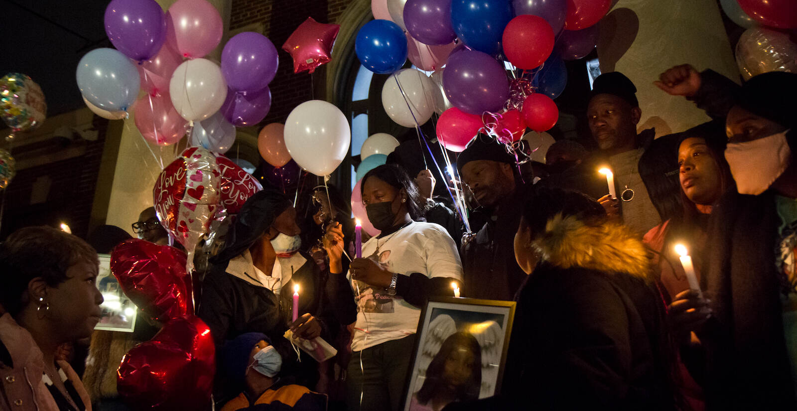 Family members of victims killed in a Fairmount rowhousefire are seen at a vigil