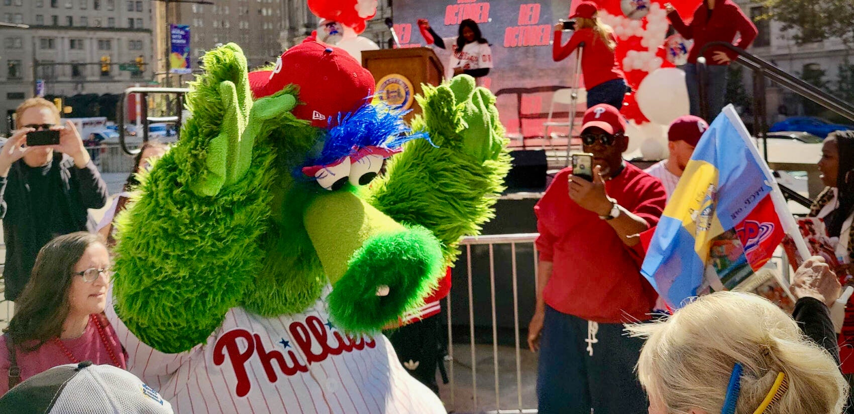 The Phillie Phanatic dances with fans at a pep rally outside City Hall for game 3 of the National League Championship Series.