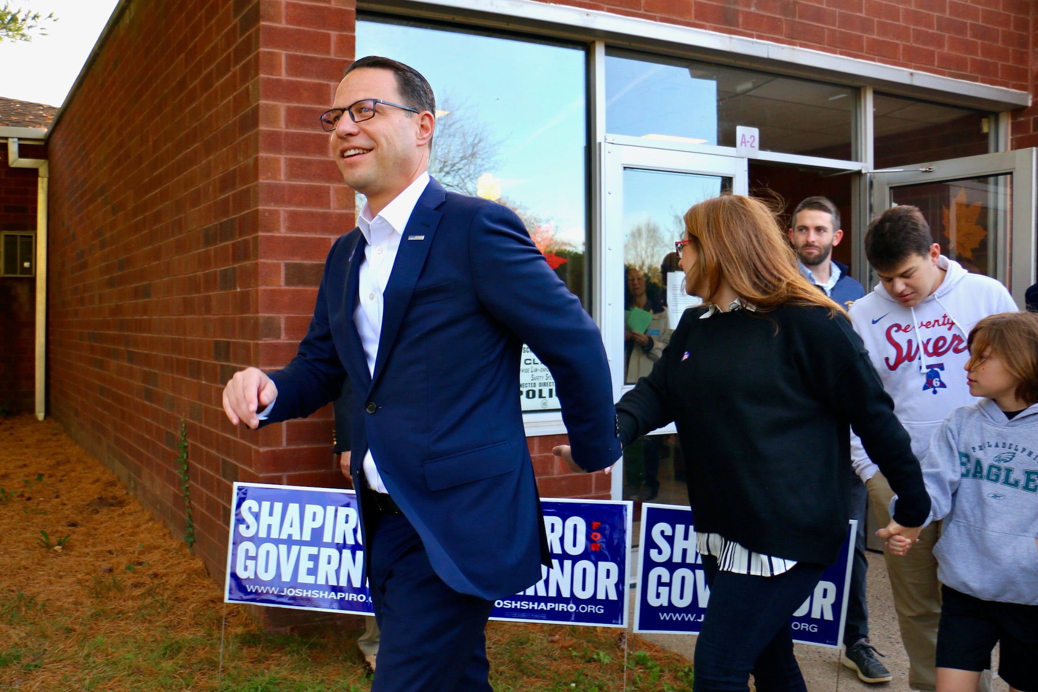Then gubernatorial candidate Josh Shapiro leaves his polling place in Abingdon, Pa., holding hands with his wife, Lori.