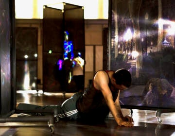A dancer performs with large-scale photography by John Dowell mounted on wheels, as part of the installation ''John Dowell: A Public Intimate Space.'' at the Barnes Foundation. (Daniel Jackson/Embassy Interactive)