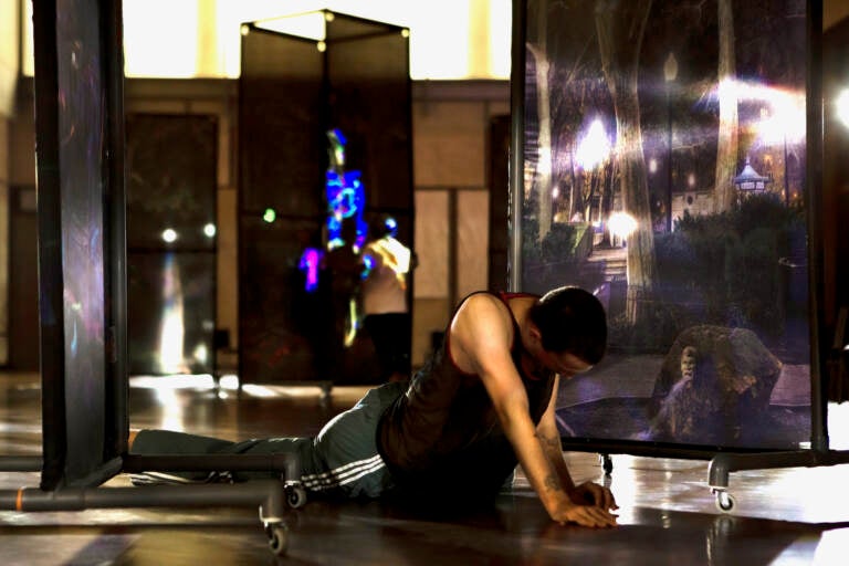 A dancer performs with large-scale photography by John Dowell mounted on wheels, as part of the installation ''John Dowell: A Public Intimate Space.'' at the Barnes Foundation. (Daniel Jackson/Embassy Interactive)