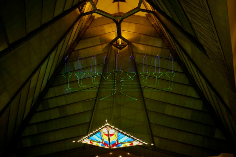 A laser-light menorah is projected into the 110-foot dome of the Beth Sholom Synagogue in Elkins Park. The synagogue will celebrate the holidays with a Hanukkah themed light show. (Emma Lee/WHYY)