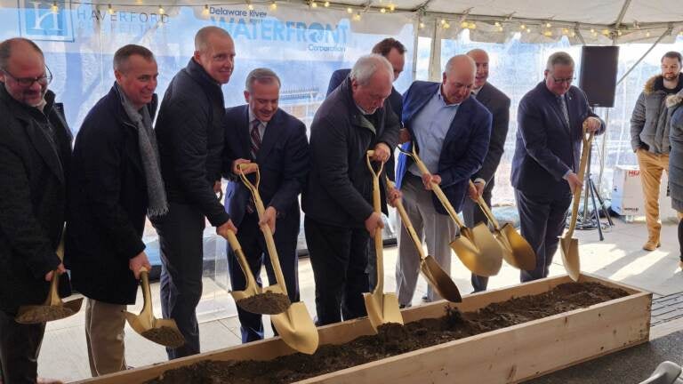 Members of the development team break ground for the mixed-use Riverview at Festival Pier. (Tom MacDonald/WHYY)