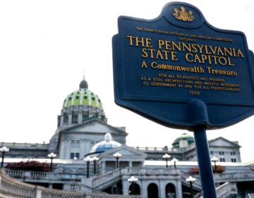 A sign is visible in front of the Pa. State Capitol building.