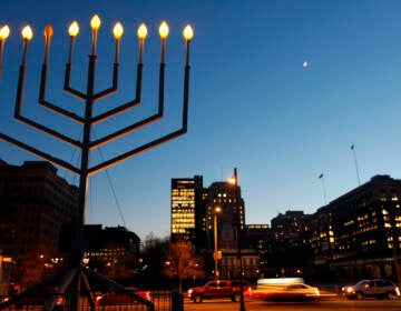 A large menorah is seen in the foreground. In the background is Independence Mall