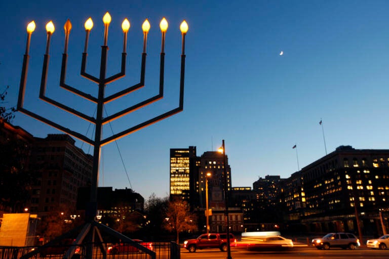 A large menorah is seen in the foreground. In the background is Independence Mall