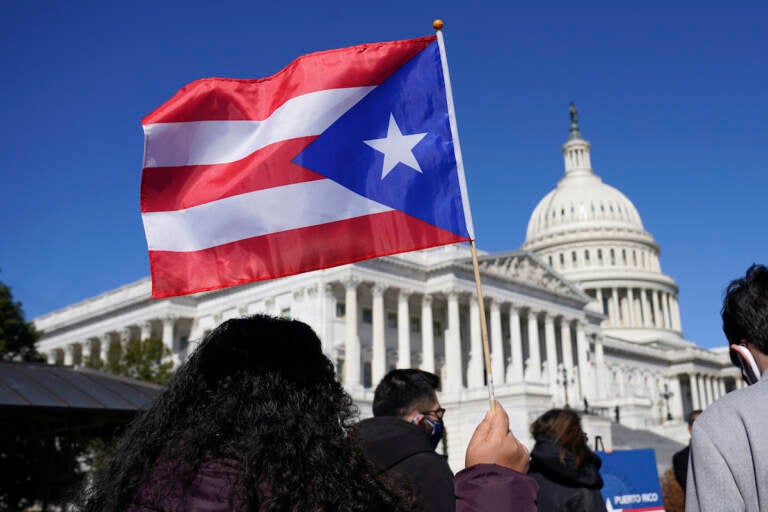 File photo: A woman waves the flag of Puerto Rico during a news conference on Puerto Rican statehood on Capitol Hill in Washington, Tuesday, March 2, 2021. (AP Photo/Patrick Semansky)