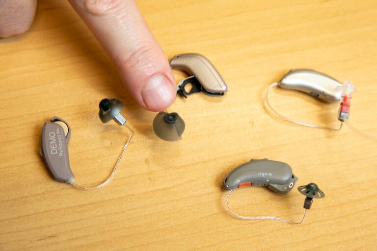 Sterling Sheffield, an assistant professor of Speech, Language, and Hearing Sciences at the University of Florida, shows over-the-counter hearing aids Wednesday, Nov. 30, 2022, in Gainesville, Fla. (AP Photo/Alan Youngblood)