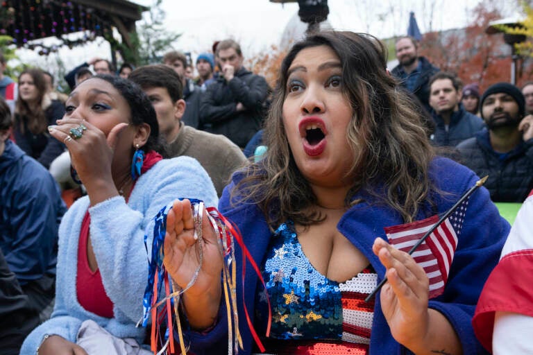 Fans of the United States soccer team Eesha Pendharkar, right, and Dania Abdalla react as they watch on television at a bar in Washington the United States team play against the Netherlands during their World Cup soccer match, Saturday, Dec. 3, 2022. (AP Photo/Manuel Balce Ceneta)