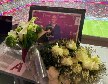 A tribute to journalist Grant Wahl is seen on his previously assigned seat at the World Cup quarterfinal soccer match between England and France, at the Al Bayt Stadium in Al Khor, Qatar, Saturday, Dec. 10, 2022. (AP Photo/Graham Dunbar)