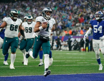 Philadelphia Eagles quarterback Jalen Hurts (1) scores a touchdown against the New York Giants during the third quarter of an NFL football game, Sunday, Dec. 11, 2022, in East Rutherford, N.J. (AP Photo/Bryan Woolston)
