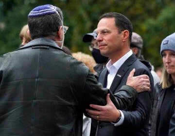 Josh Shapiro smiles at a person in a group of people.