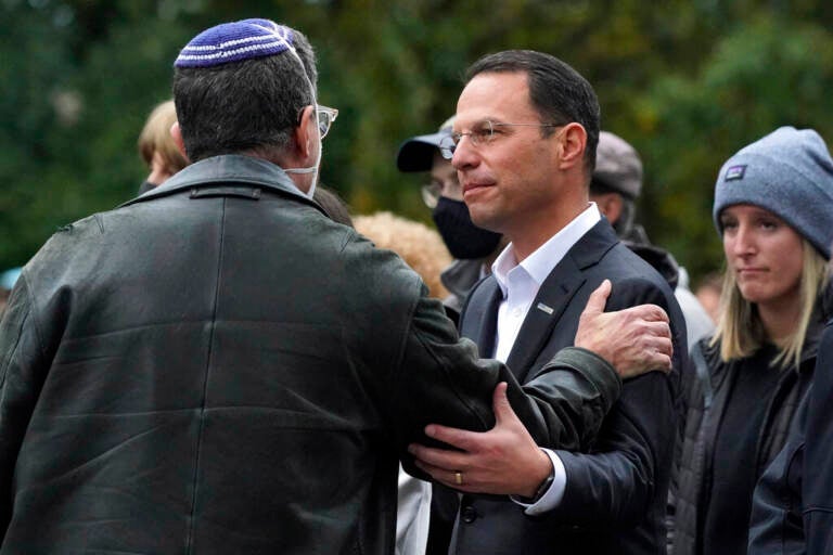 Josh Shapiro smiles at a person in a group of people.