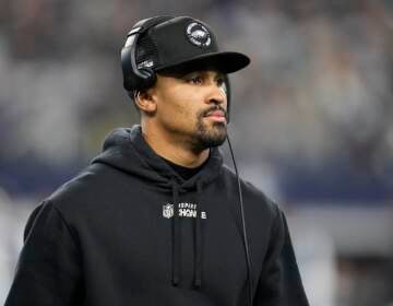 Philadelphia Eagles' Jalen Hurts is seen on the sideline during the second half of an NFL football game against the Dallas Cowboys Saturday, Dec. 24, 2022, in Arlington, Texas. (AP Photo/Tony Gutierrez)