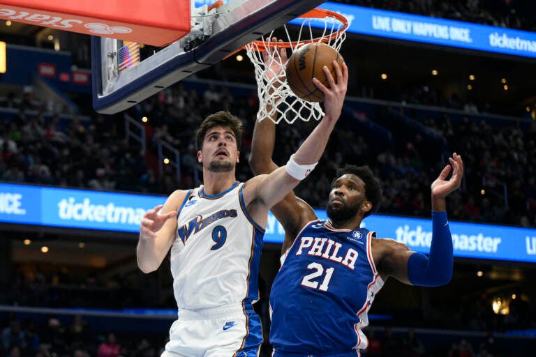 Washington Wizards forward Deni Avdija (9) goes to the basket against Philadelphia 76ers center Joel Embiid (21) during the first half of an NBA basketball game, Tuesday, Dec. 27, 2022, in Washington. (AP Photo/Nick Wass)