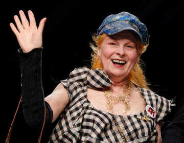 File photo: British fashion designer Vivienne Westwood waves to the audience after presenting the Vivienne Westwood fashion collection from the men's Spring/Summer 2013 collection, part of the Milan Fashion Week, unveiled in Milan,  June 24, 2012. (AP Photo/Luca Bruno, File)