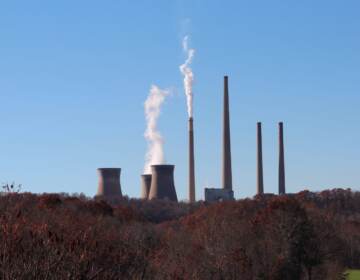 Smoke rises from factory chimneys.