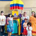 Marysol Suárez (far right) is joined by her family as characters from the film Encanto to represent Colombia. (Johnny Perez-Gonzalez/WHYY)
