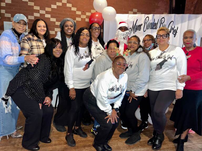 Moms Bonded by Grief's founder (fourth from right) with the moms who attended the organization's holiday party