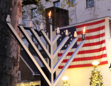 More than 150 people packed the sidewalk outside of the Betsy Ross House in Old City for a Menorah lighting on Dec. 18, 2022. (Cory Sharber/WHYY)