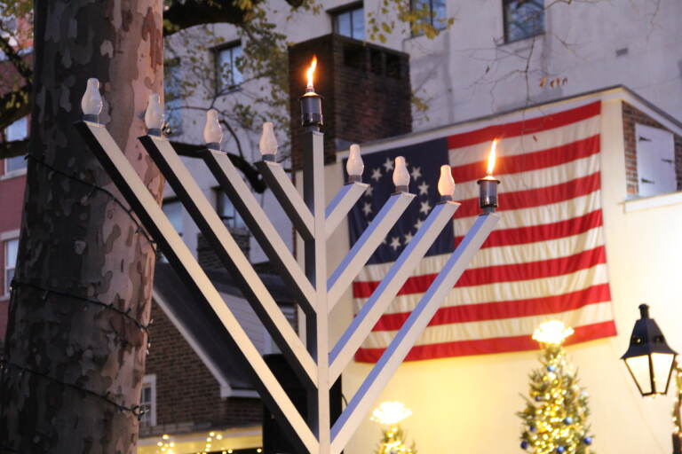 More than 150 people packed the sidewalk outside of the Betsy Ross House in Old City for a Menorah lighting on Dec. 18, 2022. (Cory Sharber/WHYY)