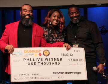 Gospel winner Frantastic Noise (center) received the check for $1,000 during Tuesday's PHL LIVE Center Stage Award Show. (Cory Sharber/WHYY)