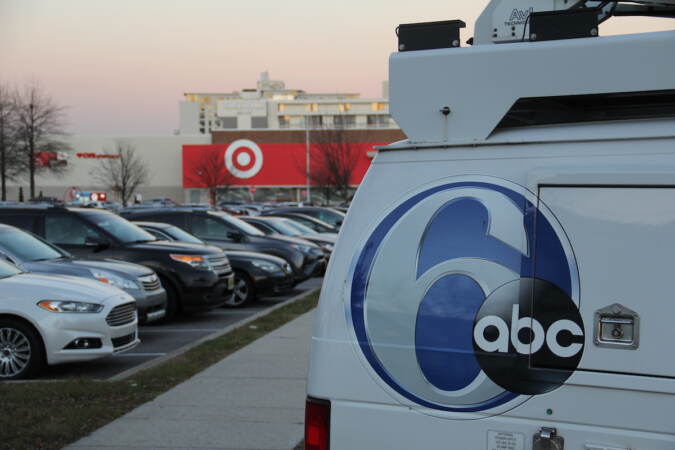 Roughly a dozen people arrived in a Target parking lot across from the 6abc Action News Studio on Dec. 21, 2022 for a tailgate honoring Jim Gardner's last show on the desk. (Cory Sharber/WHYY)