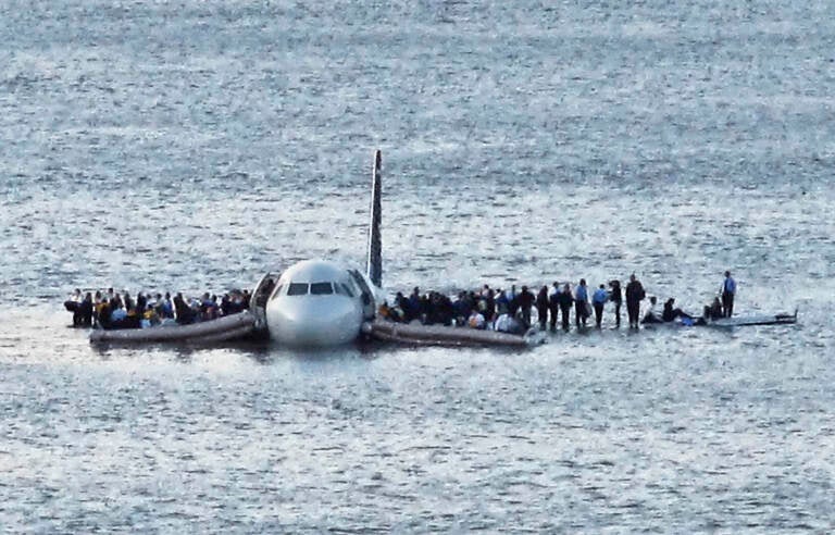 In this Thursday Jan. 15, 2009 file photo, airline passengers wait to be rescued on the wings of a US Airways Airbus 320 jetliner that safely ditched in the frigid waters of the Hudson River in New York, after a flock of birds knocked out both its engines. (AP Photo/Steven Day)