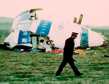 A police officer walks by the nose of Pan Am flight103 in a field near the town of Lockerbie, Scotland in 1988. (Martin Cleaver/AP)