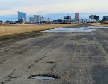 This Feb. 18, 2022 photo shows the potholed runway at the former Bader Field airport site in Atlantic City N.J. On Tuesday, Dec. 21, the City Council had been set to choose a developer for the site, but canceled the vote after a state official asked them to remove the measure from its agenda. (AP Photo/Wayne Parry)