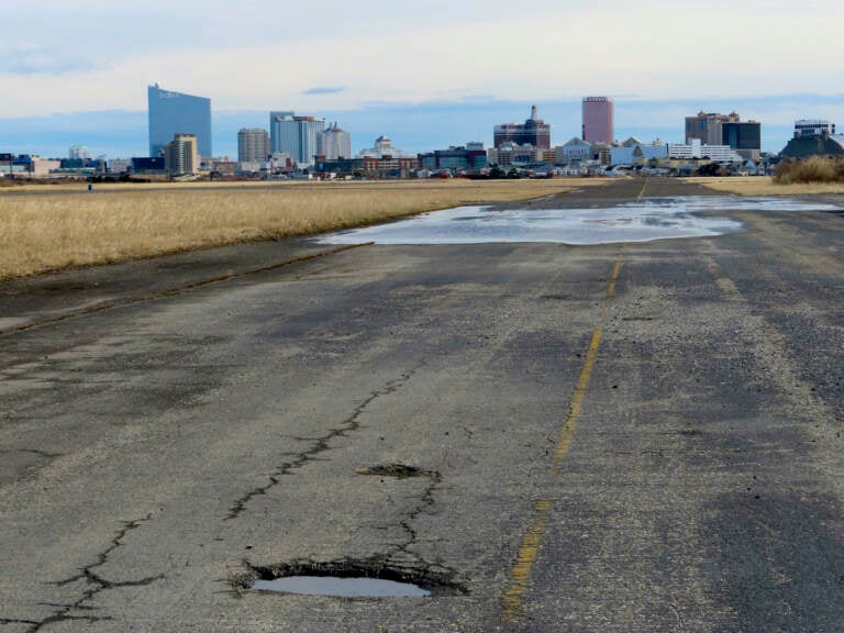 This Feb. 18, 2022 photo shows the potholed runway at the former Bader Field airport site in Atlantic City N.J. On Tuesday, Dec. 21, the City Council had been set to choose a developer for the site, but canceled the vote after a state official asked them to remove the measure from its agenda. (AP Photo/Wayne Parry)