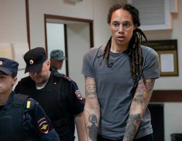 Brittney Griner is escorted from a courtroom