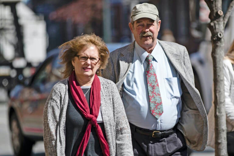 FILE – Deborah Frein, left, and Eugene Michael Frein, right, the parents of Eric Frein, walk to the Chester County Justice Center in West Chester, Pa., March 9, 2017. The parents of gunman Eric Frein, who killed a Pennsylvania state trooper and permanently disabled another eight years ago in an ambush of a police barracks, have settled a lawsuit that accused them of partial responsibility for the attack. A Lackawanna County judge was to hear arguments on the motion Oct. 31, 2022, but court documents indicate that he was advised that the case had been settled, the Wilkes-Barre Citizens' Voice reported. (AP Photo/Matt Rourke, File)