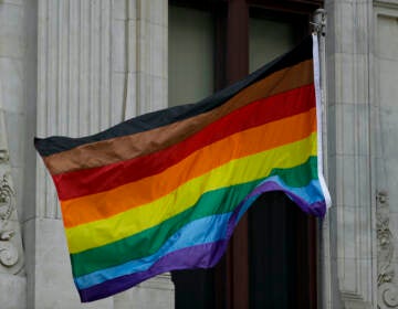 FILE - Philadelphia's altered gay pride flag is seen outside City Hall on  June 19, 2017, in Philadelphia. Pennsylvania government regulations would be revised with extensive definitions of sex, religious creed and race under a proposal set for a vote on Thursday, Dec. 8, 2022 — a change some Republican lawmakers see as an overreach on a subject they think should not be addressed without legislation. (AP Photo/Matt Slocum, File)