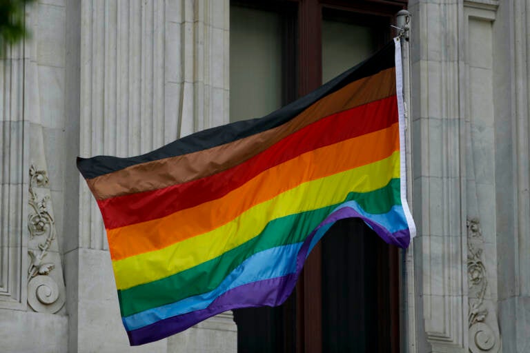 FILE - Philadelphia's altered gay pride flag is seen outside City Hall on  June 19, 2017, in Philadelphia. Pennsylvania government regulations would be revised with extensive definitions of sex, religious creed and race under a proposal set for a vote on Thursday, Dec. 8, 2022 — a change some Republican lawmakers see as an overreach on a subject they think should not be addressed without legislation. (AP Photo/Matt Slocum, File)