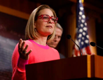 U.S. Sen. Kyrtsen Sinema speaks from a podium
