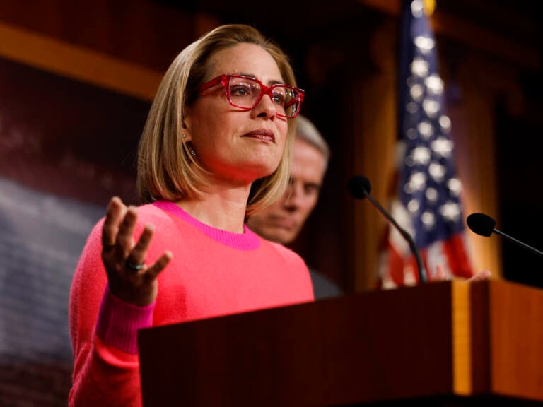 U.S. Sen. Kyrtsen Sinema speaks from a podium