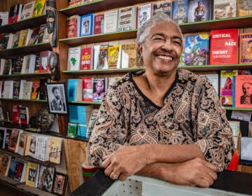 Yvonne Blake stands in front of shelves of books