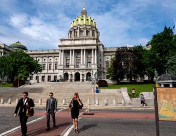 People walk outside the Pennsylvania Capitol Building