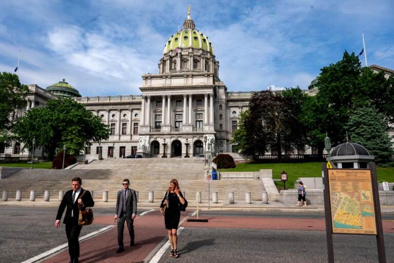 People walk outside the Pennsylvania Capitol Building