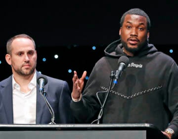 FILE - Musician Meek Mill, right, speaks about his incarceration along with Philadelphia 76ers co-owner Michael Rubin at the launch of REFORM Alliance in New York on Jan. 23, 2019. The pair shared laughs Tuesday, Dec. 13, 2022, at an outing meant to brighten the day for kids from families caught in the criminal justice system. (AP Photo/Kathy Willens, File)