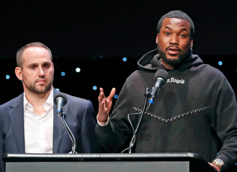 FILE - Musician Meek Mill, right, speaks about his incarceration along with Philadelphia 76ers co-owner Michael Rubin at the launch of REFORM Alliance in New York on Jan. 23, 2019. The pair shared laughs Tuesday, Dec. 13, 2022, at an outing meant to brighten the day for kids from families caught in the criminal justice system. (AP Photo/Kathy Willens, File)