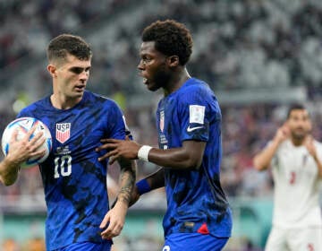 Christian Pulisic of the United States, left, and Yunus Musah of the United States speak before a free kick during the World Cup group B soccer match between Iran and the United States at the Al Thumama Stadium in Doha, Qatar, Tuesday, Nov. 29, 2022. (AP Photo/Ebrahim Noroozi)