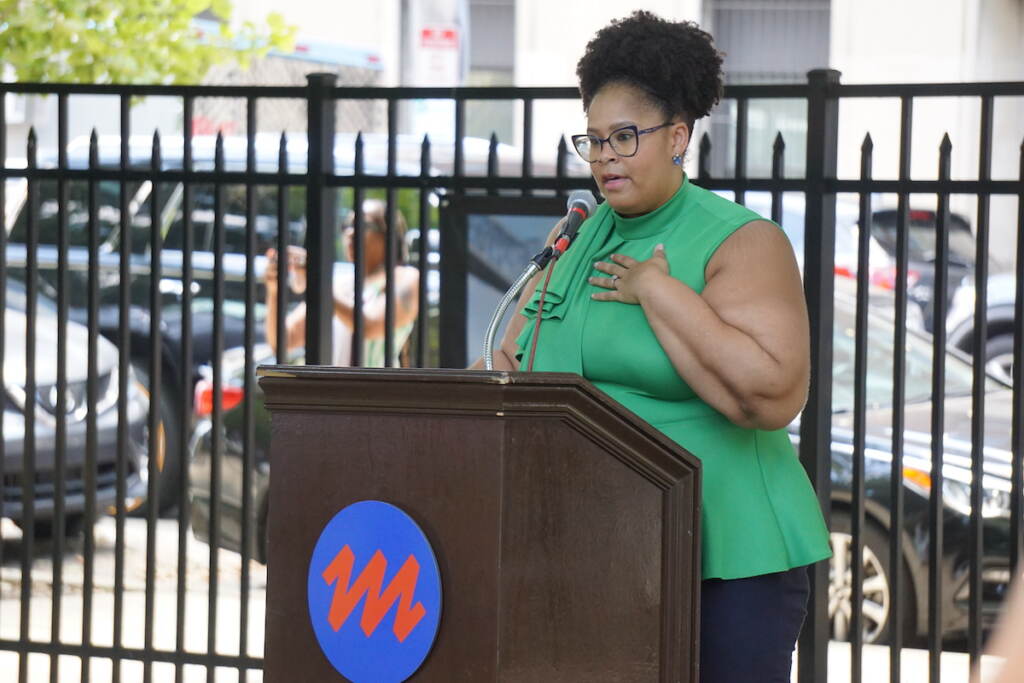 A woman speaks at a podium.