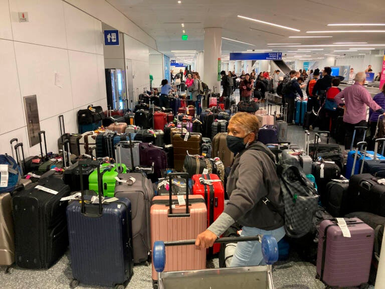 Baggage waits to be claimed after canceled flights at the Southwest Airlines terminal at Los Angeles International Airport